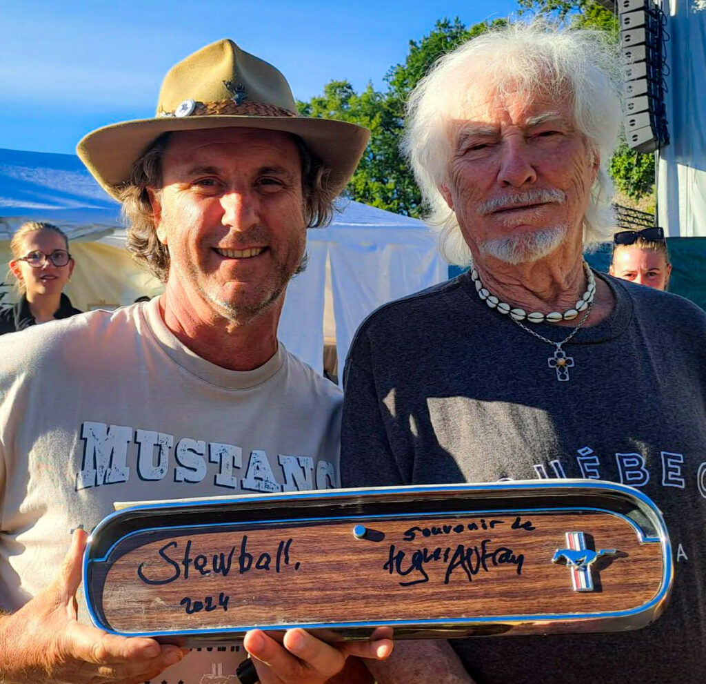 Damien with French singer Hugues Aufray signing his 1965 Ford Mustang convertible named Stewball