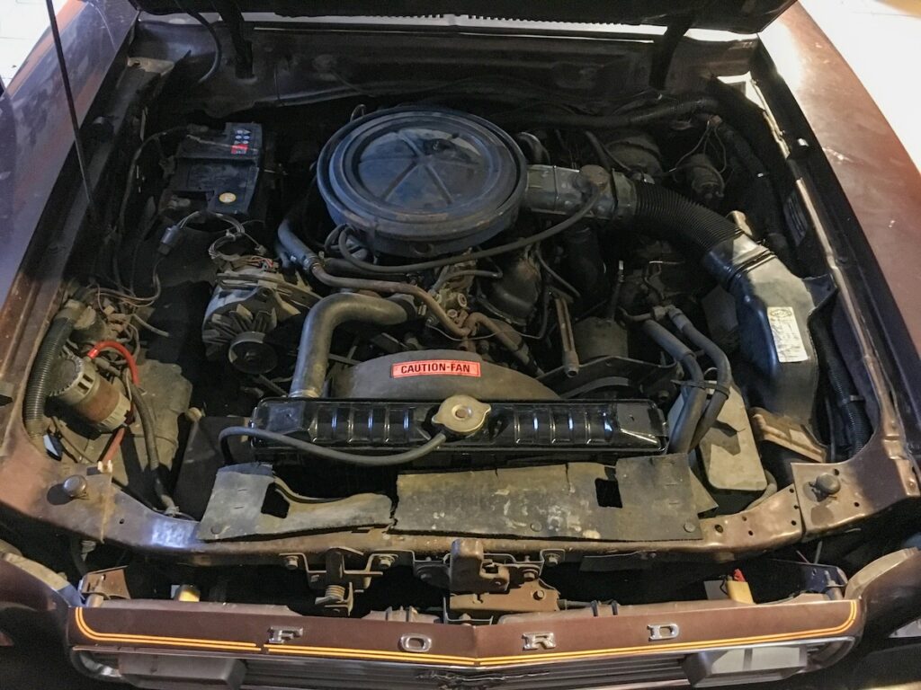 Engine bay of a 1977 Mustang II survivor in original unrestored condition