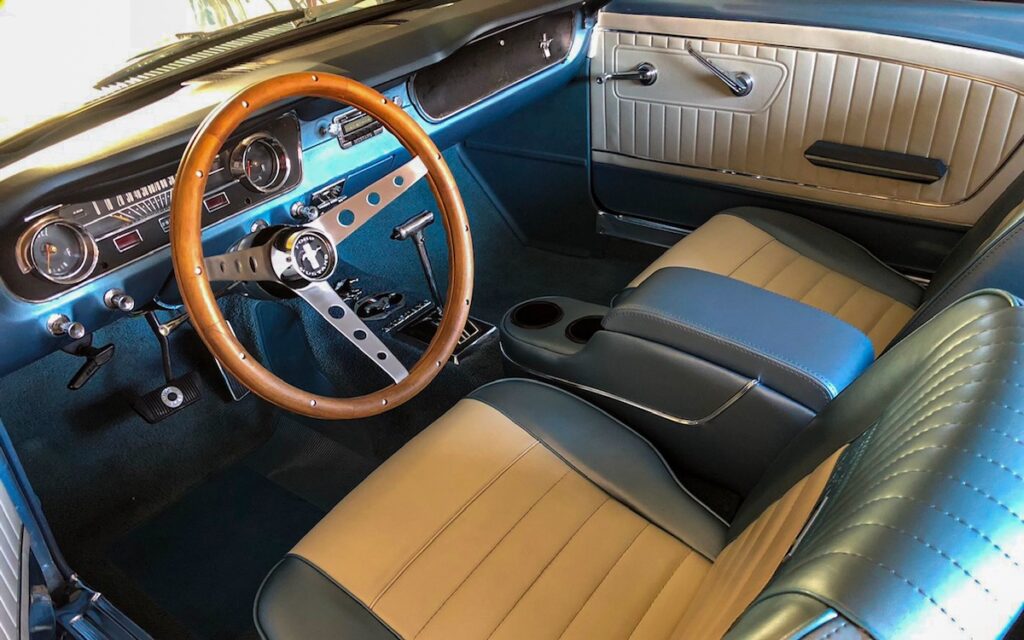 Interior of a 1965 Mustang Coupe with classic dashboard and seats
