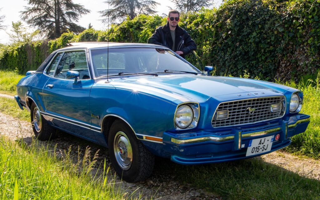 Antonin standing next to his 1974 Ford Mustang II Ghia