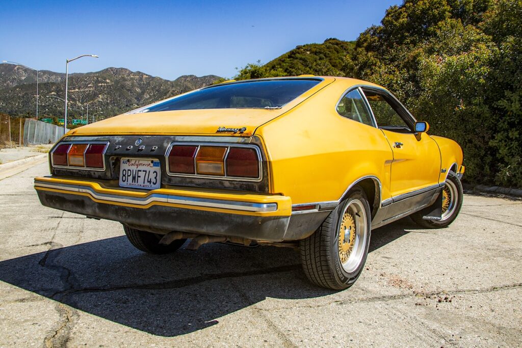 Rear view of Mustang II Mach 1 driving in Los Angeles