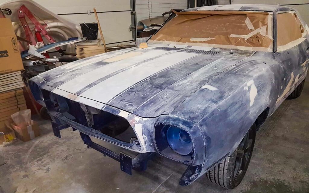 Restoring a 1975 Mustang II bodywork, sanding the blue paint after a failed paint job