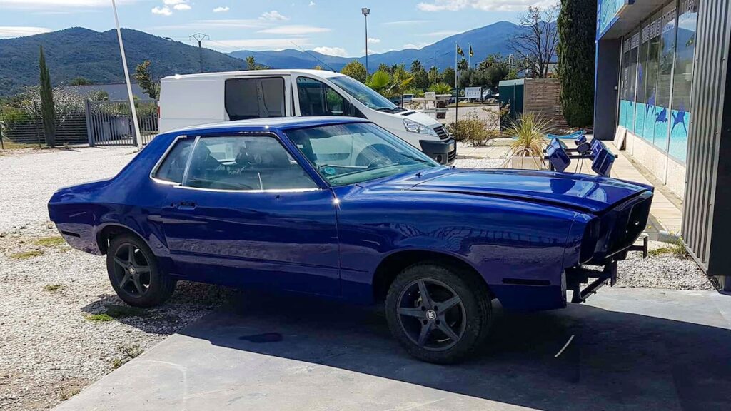 1975 Mustang II fresh blue paint after restoration, exiting the paint booth