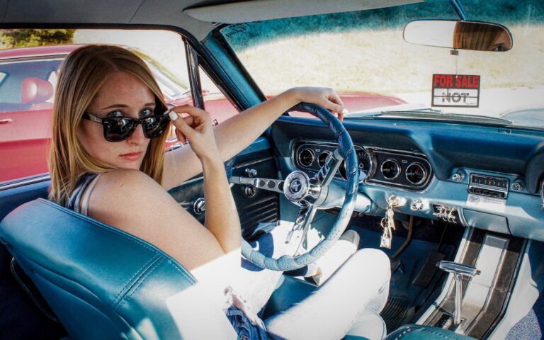 Marissa behind the wheel of her 1966 Mustang, driving it just like it was meant to be: every single day.