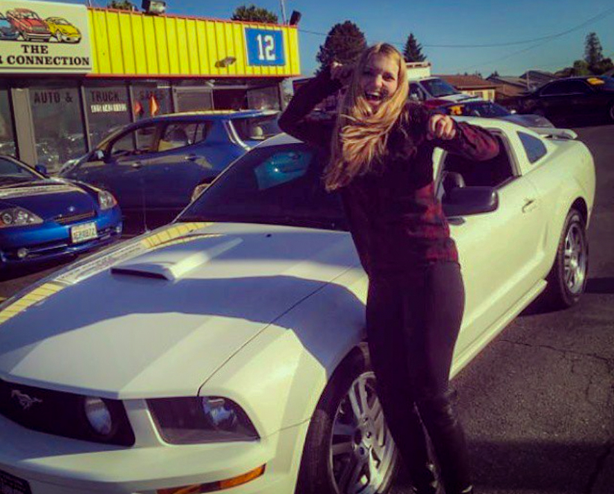 A very happy Brittley with the white 2005 Mustang GT she bought at 19. The car would soon become Jane — and change far more than she could have imagined.