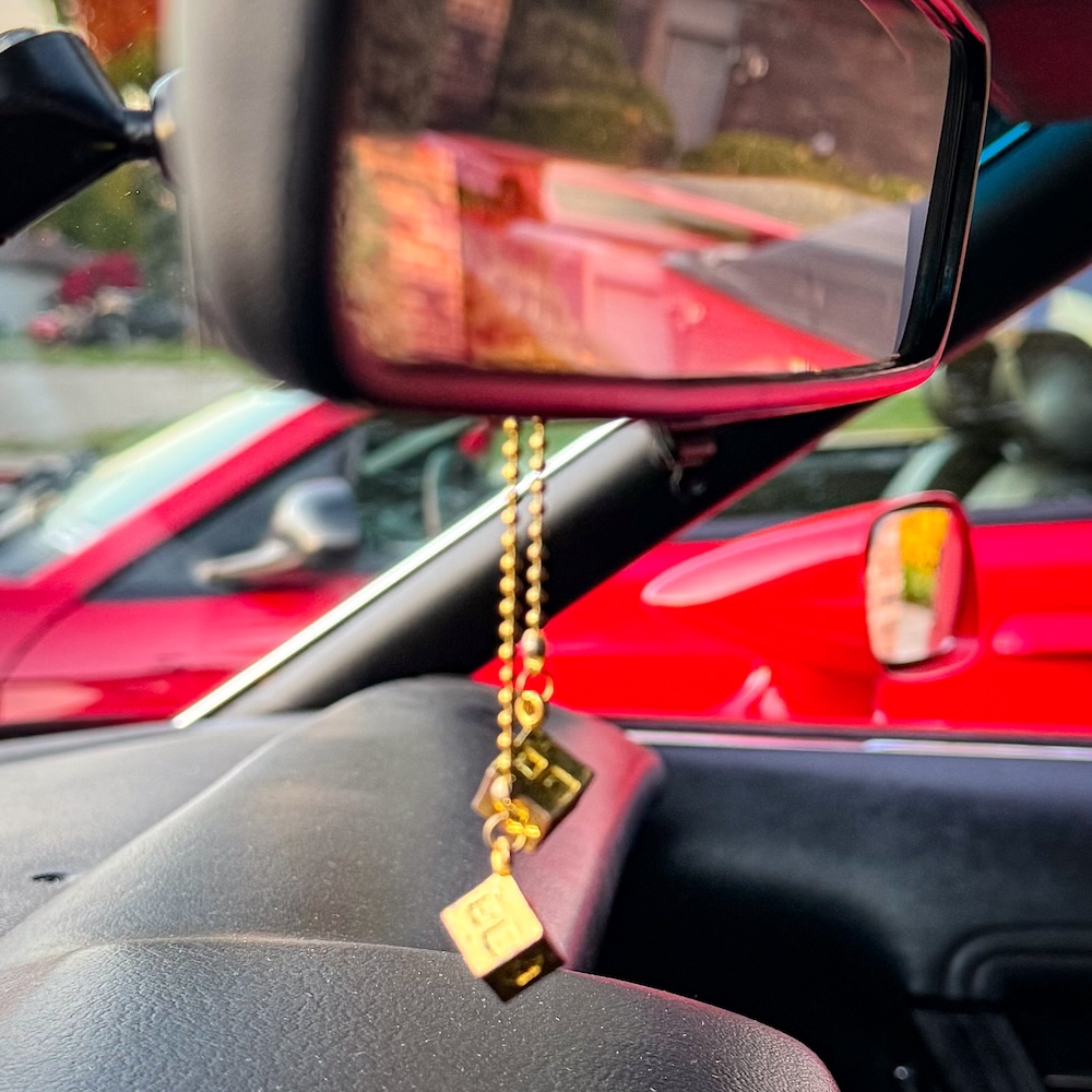 Han Solo lucky dice hanging from the rearview mirror of Heather's Mustang