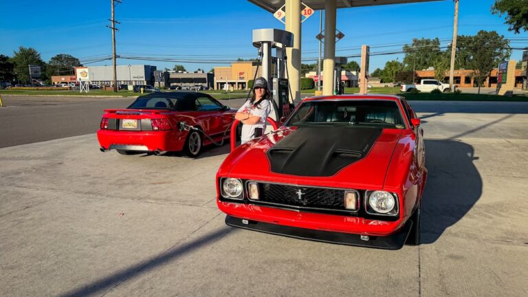 Heather Jastrzemski with her red 1973 Mustang Mach 1 and 2004 Mustang GT Convertible