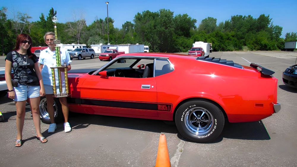 Heather and Frank Reeves with their 1973 Mustang Mach 1 at a USMA show in 2013
